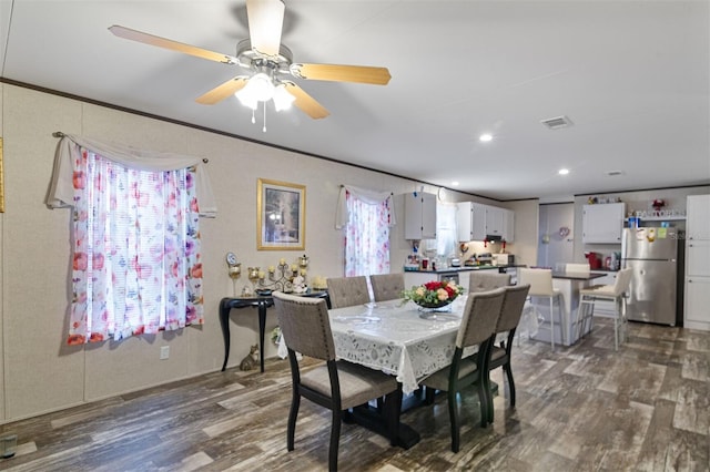 dining area featuring dark hardwood / wood-style floors, ceiling fan, and ornamental molding