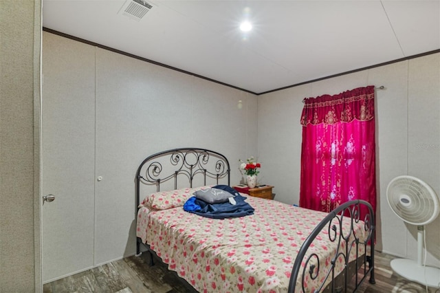 bedroom with dark wood-type flooring