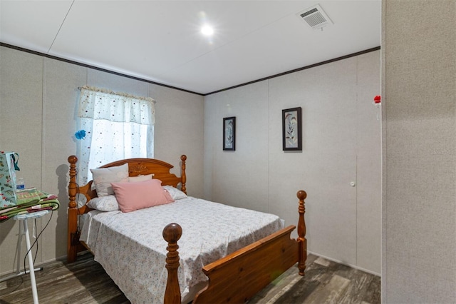 bedroom featuring dark hardwood / wood-style flooring and ornamental molding