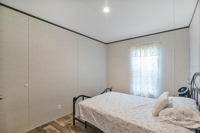 bedroom featuring dark wood-type flooring and ornamental molding