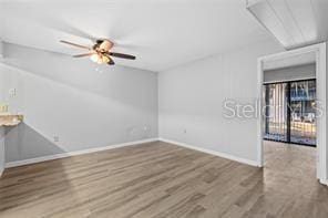 empty room featuring ceiling fan and wood-type flooring