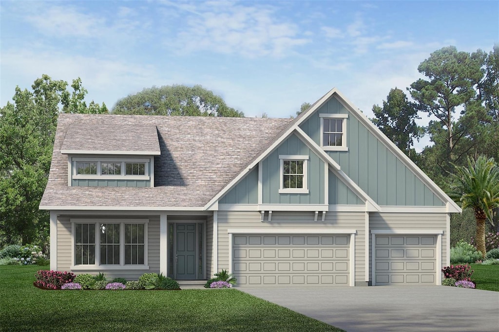 view of front of property with a front lawn and a garage