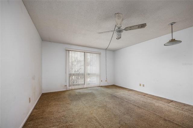 carpeted empty room with a textured ceiling and ceiling fan