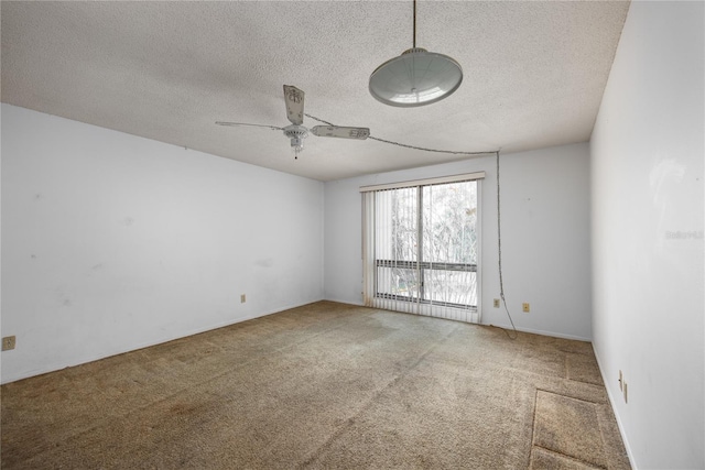 spare room featuring carpet, a textured ceiling, ceiling fan, and a baseboard heating unit