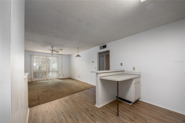 unfurnished room featuring ceiling fan, a textured ceiling, and hardwood / wood-style flooring