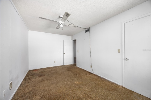 unfurnished bedroom featuring ceiling fan, carpet floors, and a textured ceiling