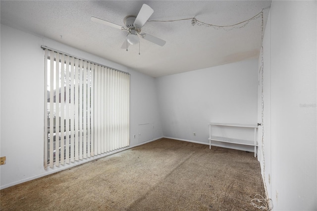 carpeted empty room featuring ceiling fan and a textured ceiling