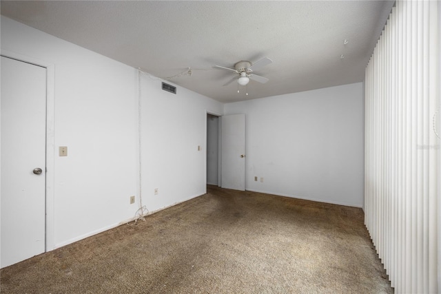 unfurnished room featuring ceiling fan, carpet, and a textured ceiling