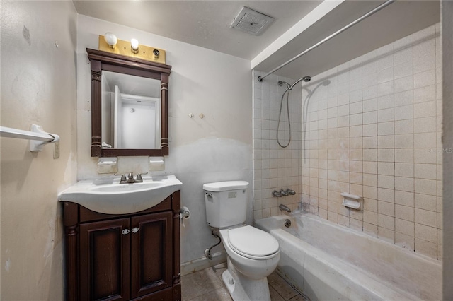 full bathroom featuring toilet, vanity, tiled shower / bath combo, and tile patterned flooring