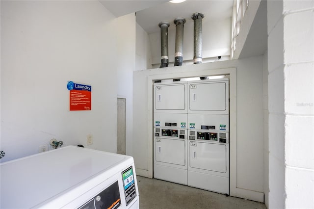 washroom featuring stacked washer / dryer