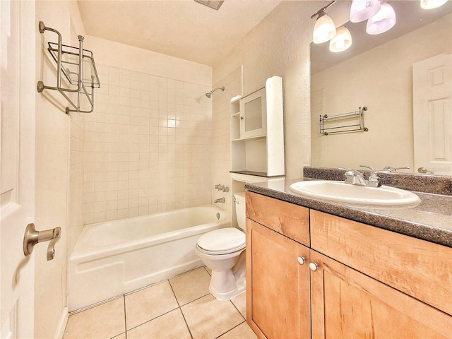 full bathroom featuring tile patterned flooring, vanity, toilet, and tiled shower / bath