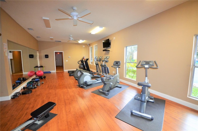 workout area with ceiling fan, plenty of natural light, and hardwood / wood-style flooring