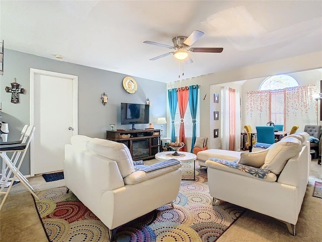 carpeted living room with ceiling fan