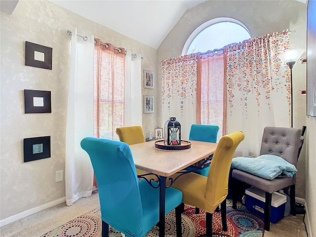 dining area with vaulted ceiling