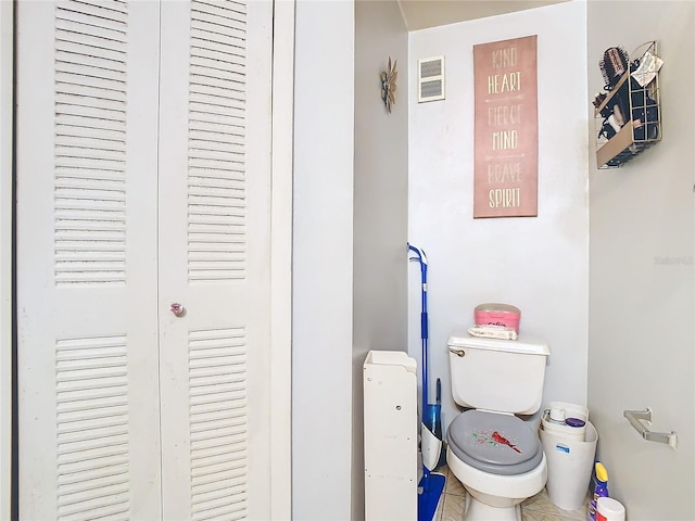 bathroom with tile patterned flooring and toilet