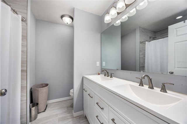 bathroom featuring a shower with curtain, vanity, and toilet