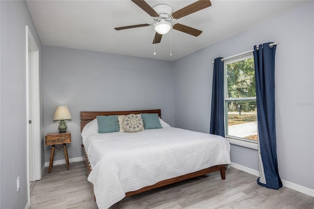 bedroom with light hardwood / wood-style floors and ceiling fan