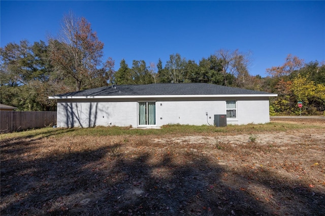 rear view of property with central AC