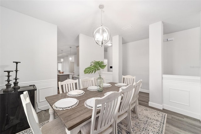 dining room featuring a chandelier and wood-type flooring