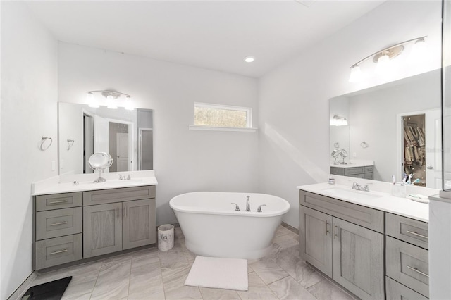 bathroom with vanity and a tub to relax in