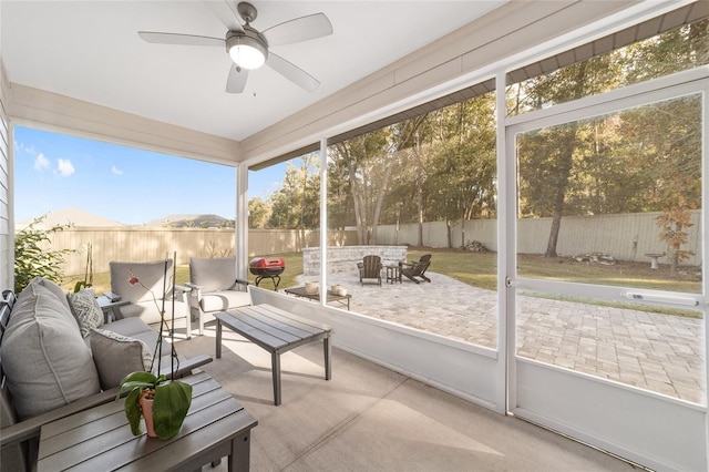 sunroom / solarium with ceiling fan and a wealth of natural light