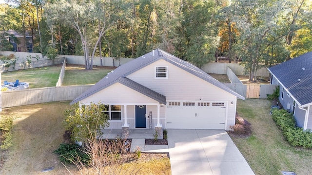 view of front of house featuring a front lawn and a garage