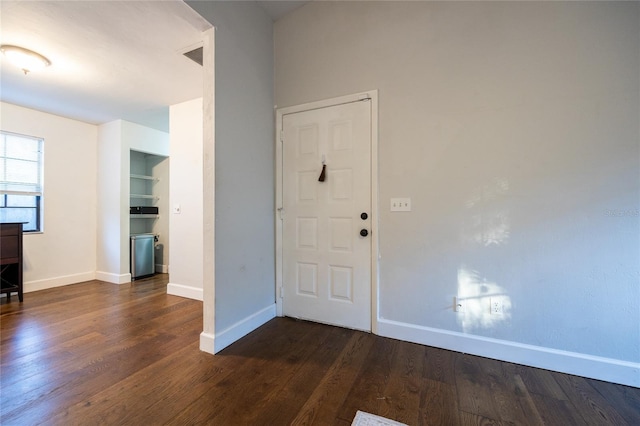 entrance foyer with dark hardwood / wood-style floors