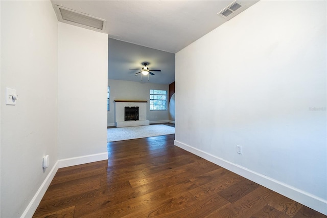 unfurnished living room featuring dark hardwood / wood-style flooring and ceiling fan