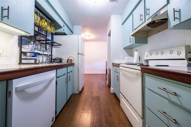 kitchen featuring white appliances, dark hardwood / wood-style floors, white cabinetry, and backsplash