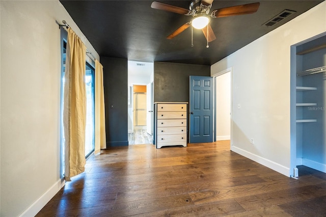 unfurnished bedroom featuring dark hardwood / wood-style flooring, a closet, and ceiling fan