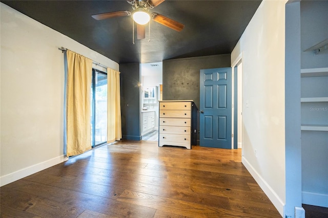 unfurnished bedroom with ceiling fan and dark hardwood / wood-style flooring