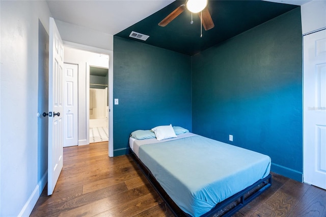 bedroom with ceiling fan and dark hardwood / wood-style flooring