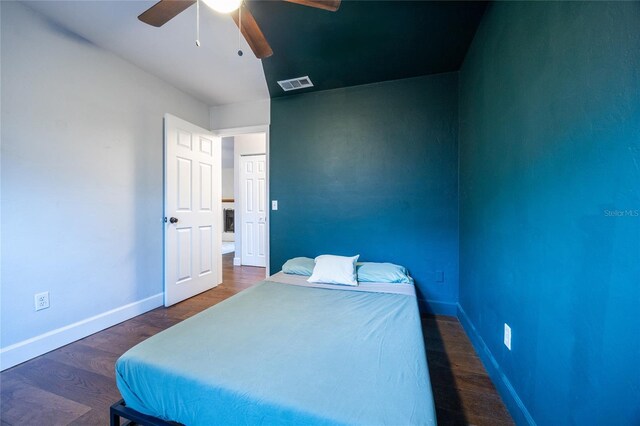 bedroom with ceiling fan and dark wood-type flooring