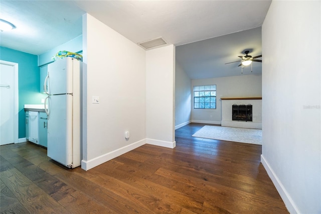 2116 SW 73rd St, Gainesville, FL 32607 - unfurnished living room with a ceiling fan, dark wood-style flooring, and a fireplace with raised hearth