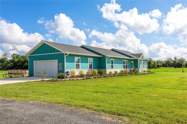 single story home featuring a garage and a front lawn