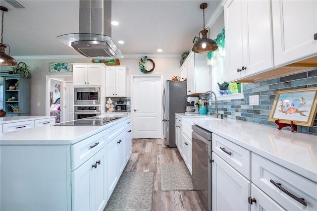 kitchen featuring white cabinets, appliances with stainless steel finishes, island range hood, and hanging light fixtures