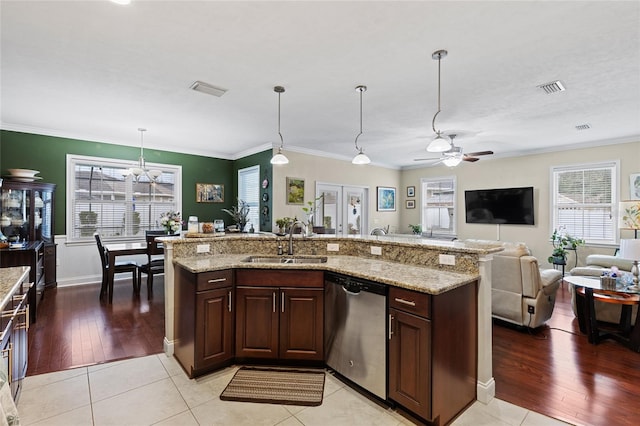 kitchen with stainless steel dishwasher, a healthy amount of sunlight, light wood-type flooring, and sink