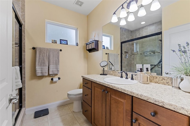 bathroom with tile patterned flooring, vanity, toilet, and an enclosed shower
