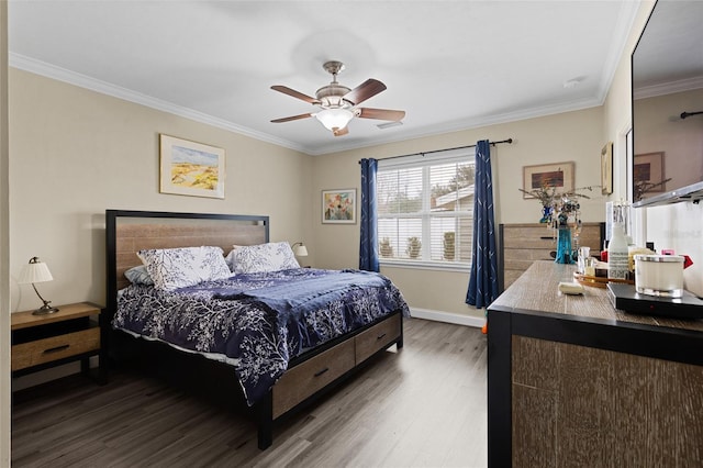 bedroom with hardwood / wood-style floors, ceiling fan, and crown molding