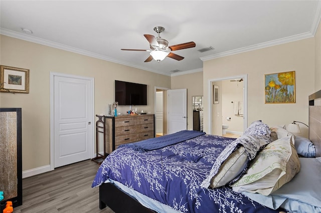 bedroom featuring hardwood / wood-style floors, ensuite bathroom, ceiling fan, and ornamental molding