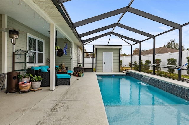 view of swimming pool featuring outdoor lounge area, a storage unit, a lanai, pool water feature, and a patio area