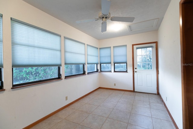 spare room with ceiling fan and light tile patterned flooring