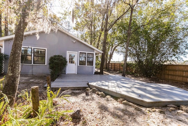 rear view of property featuring a wooden deck