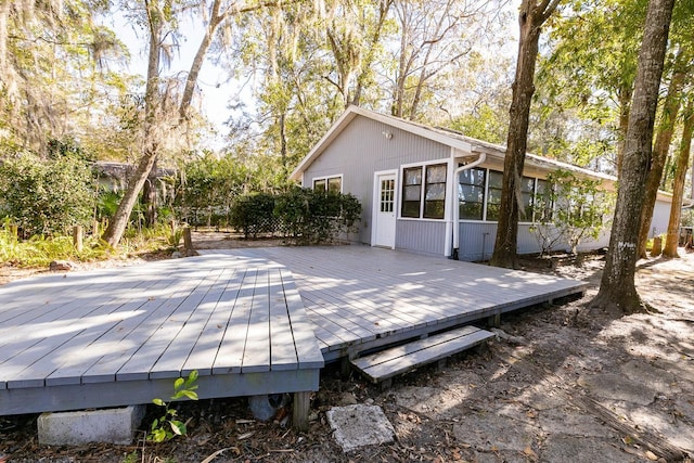 wooden deck with a sunroom