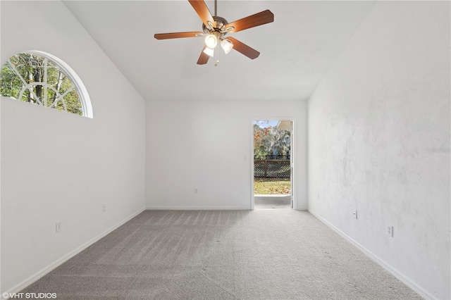 carpeted empty room featuring ceiling fan and lofted ceiling