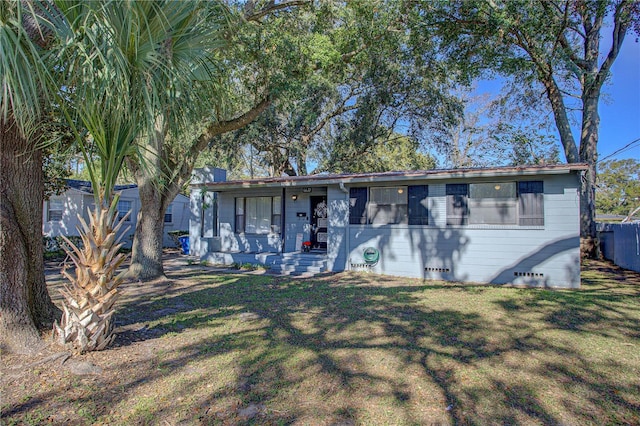 ranch-style home featuring a porch and a front lawn