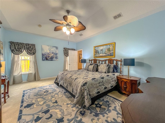 bedroom with ceiling fan and light carpet