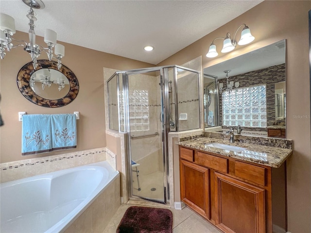 bathroom with tile patterned floors, vanity, plus walk in shower, and a textured ceiling