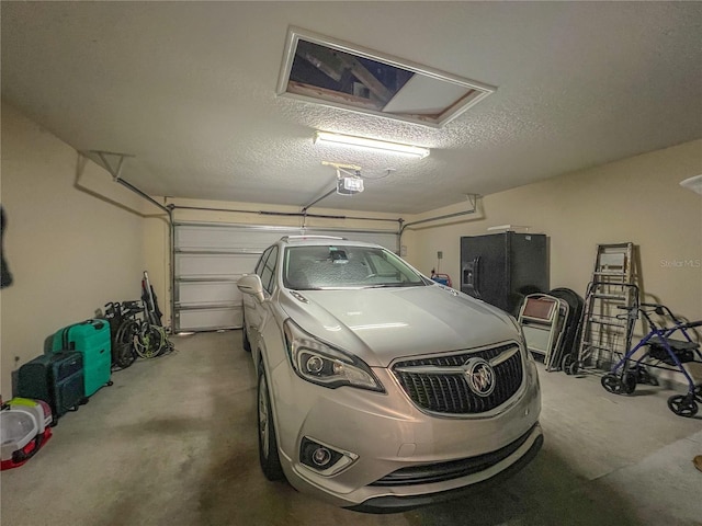 garage with black fridge and a garage door opener