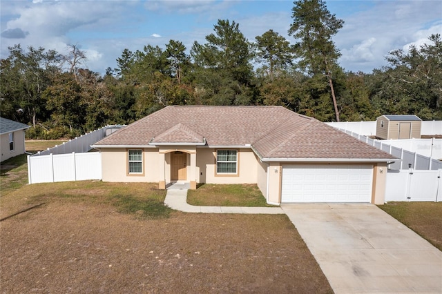 view of front of home with a front yard and a garage